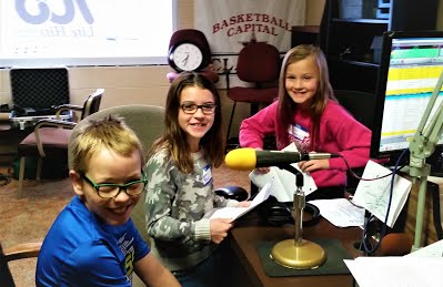 Three kids doing a radio show