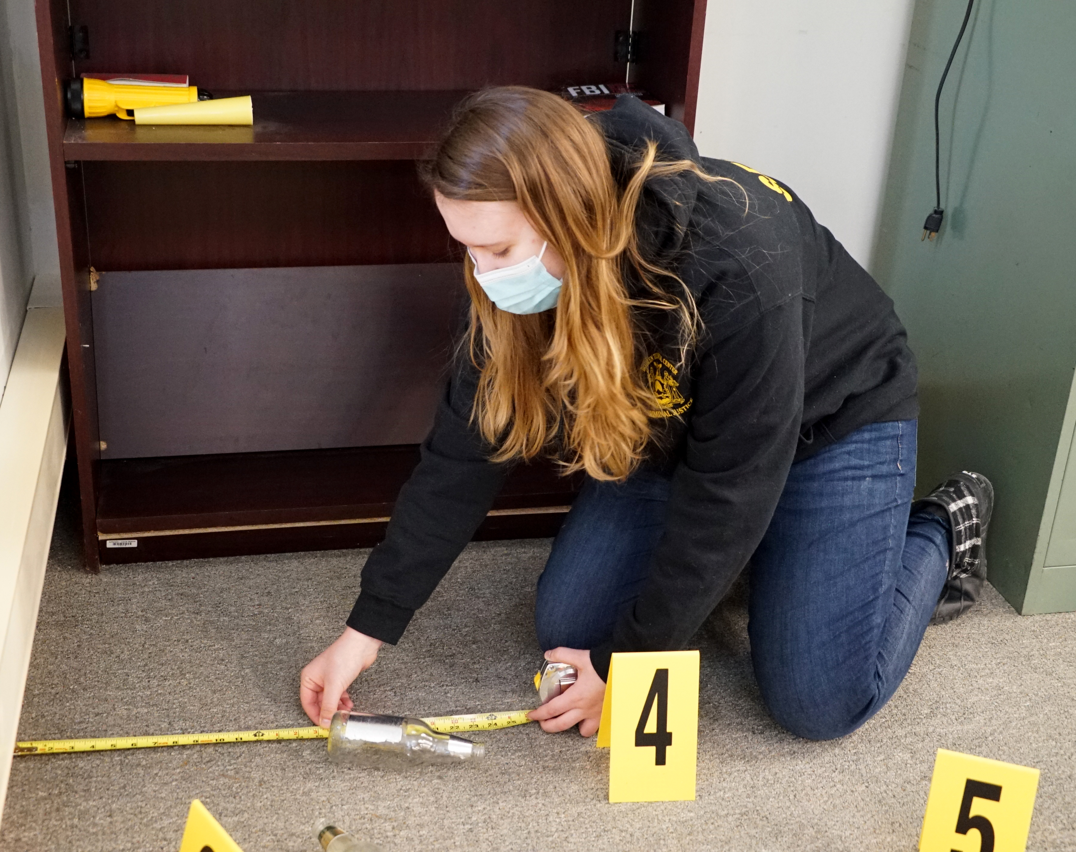 student investigating crime scene