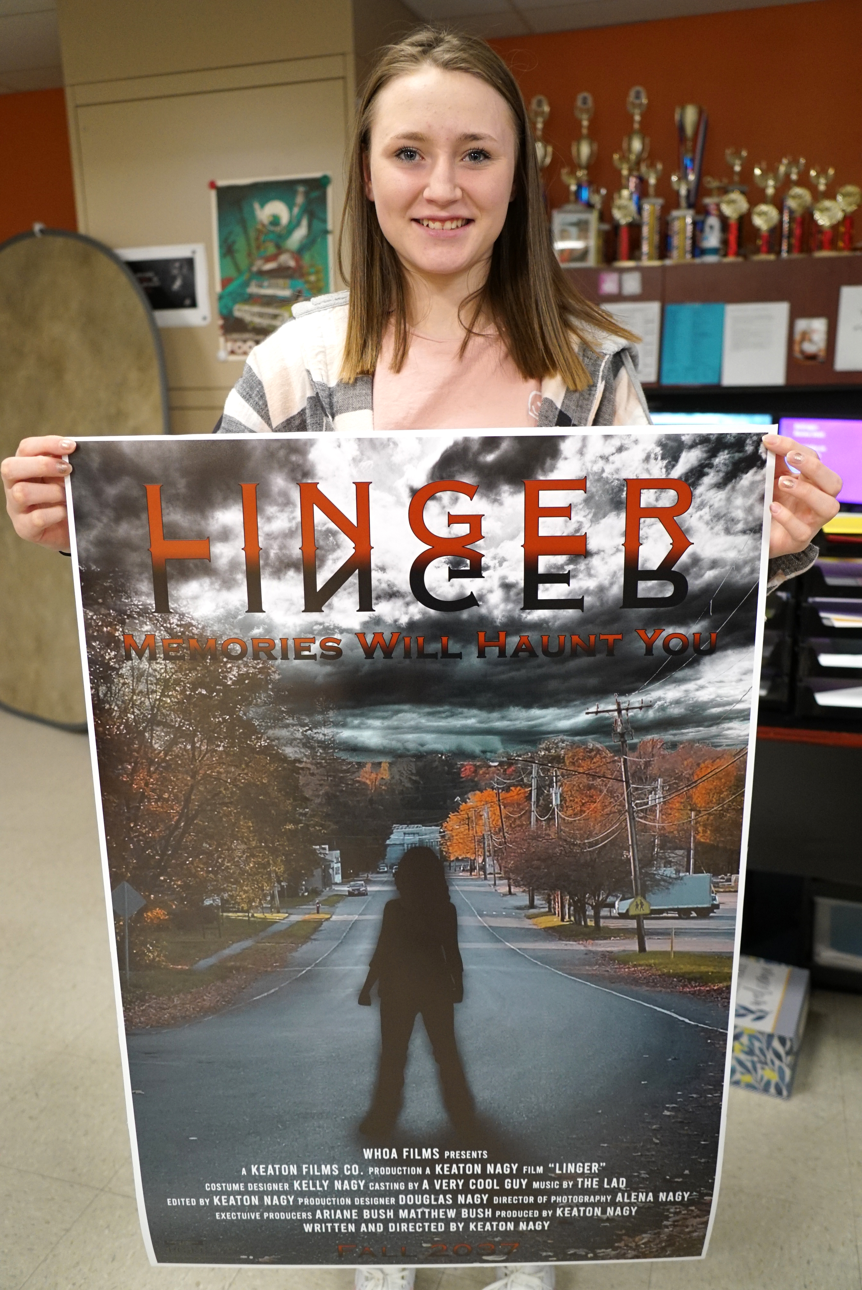 student holding poster